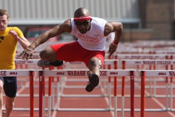 Emmanuel Aouad clearing a hurdle in a Wabash College uniform.